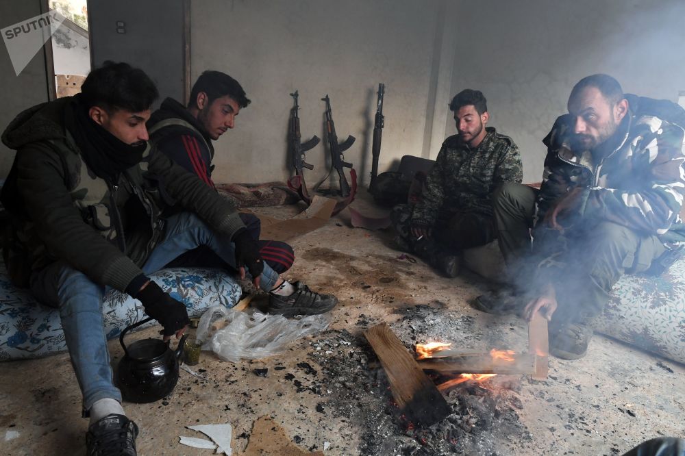 عناصر الدفاع الوطنى خلال استراحة بعد تحرير بلدة من البلدات فى محافظة إدلب