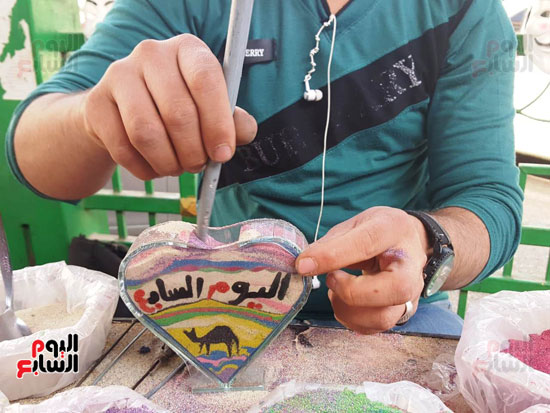 عمر تحدى البطالة فتعلم الرسم على  الرمال ووقف بشوارع اسيوط يعرض موهبته (18)
