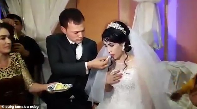 عريس يطعم عروسته كعكة الزفاف