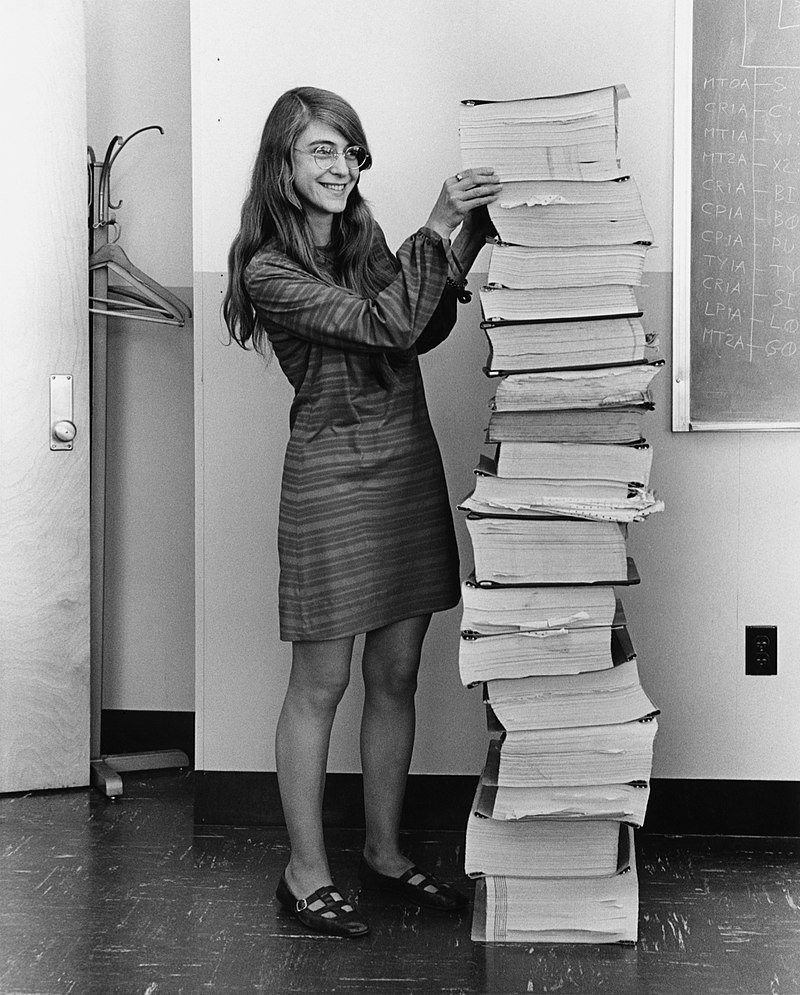 Margaret Hamilton alongside the code that got us to the moon
