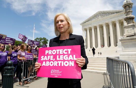 ناشطة-تحمل-لافتة-تدعو-لحماية-الإجهاض-الآمن-والقانونى