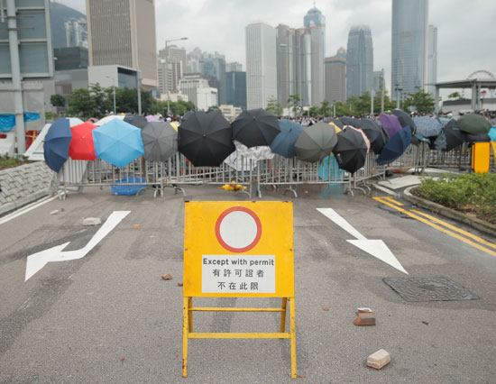 متظاهرون يغلقون شارع قرب مكاتب الحكومة فى هونج كونج
