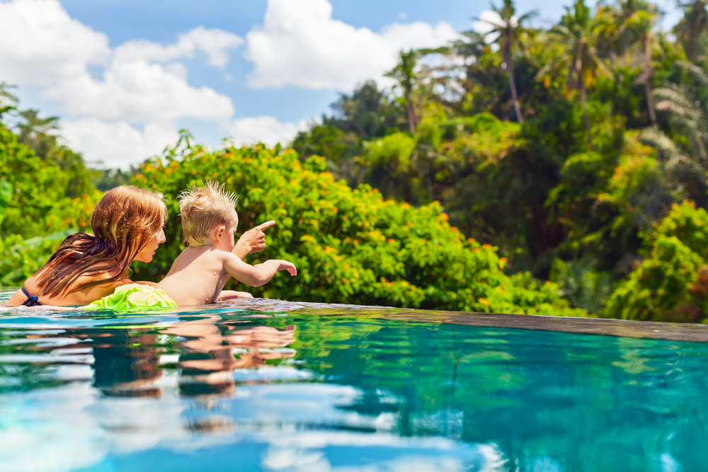 A-Guide-to-Travel-for-Single-Parents-Mom-Son-in-a-Pool