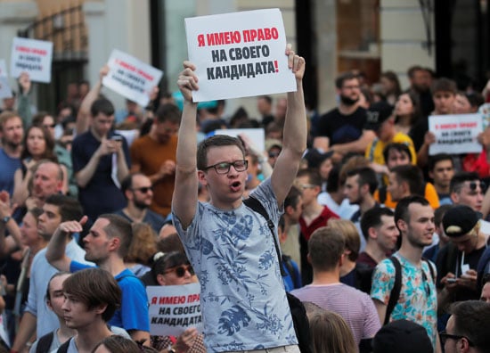 Young man holding a playcard during Moscow protests