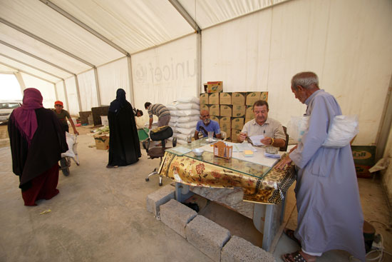 يتلقى-النازحون-العراقيون-المساعدات-في-مخيم-حسن-شم-فى-الموصل