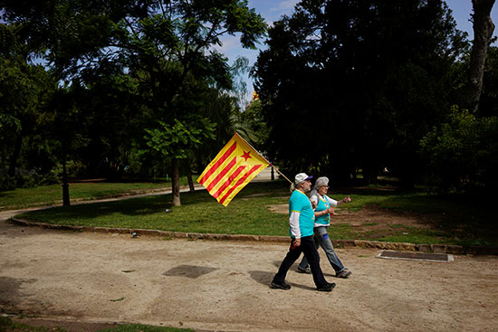 زوجان يرفعان علم إقليم كتالونيا خلال المظاهرات