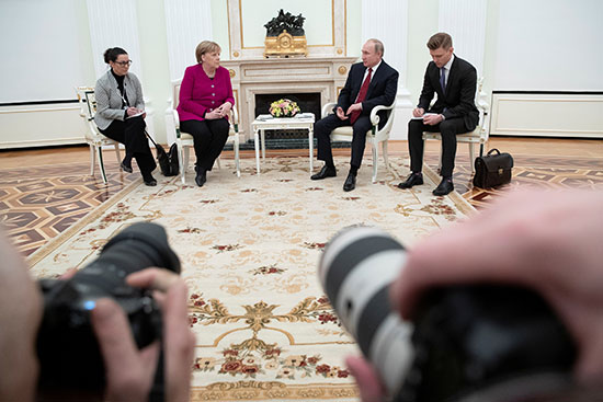 المستشارة الألمانية أنجيلا ميركل تستمع إلى الرئيس الروسي فلاديمير بوتين خلال المحادثات في الكرملين