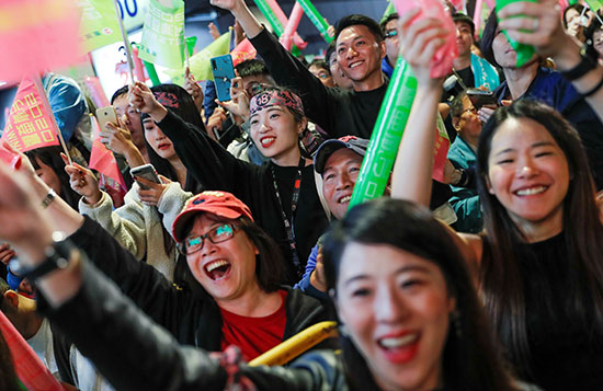 مؤيدو رئيس تايوان تساي إنج ون يحملون لافتات خلال تجمع حاشد خارج مقر الحزب التقدمي الديمقراطي