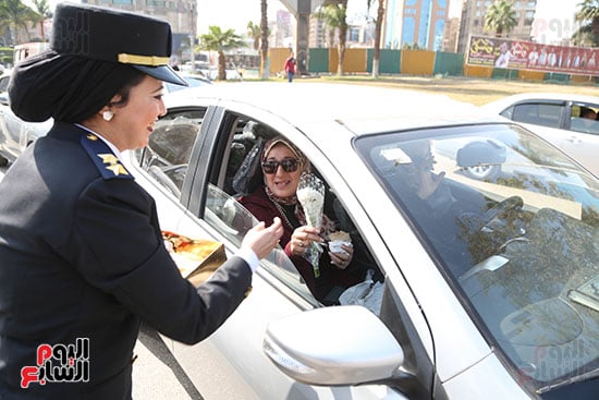 توزيع الورود والحلوى على مستقلى السيارات بميدان مصطفى محمود