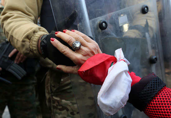 متظاهرة-تضع-يدها-على-جندى-لبنانى