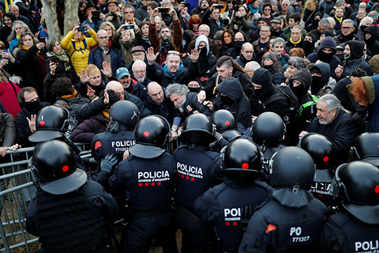 يواجه المتظاهرون أفراد قوات الأمن أمام برلمان كاتالونيا في برشلونة