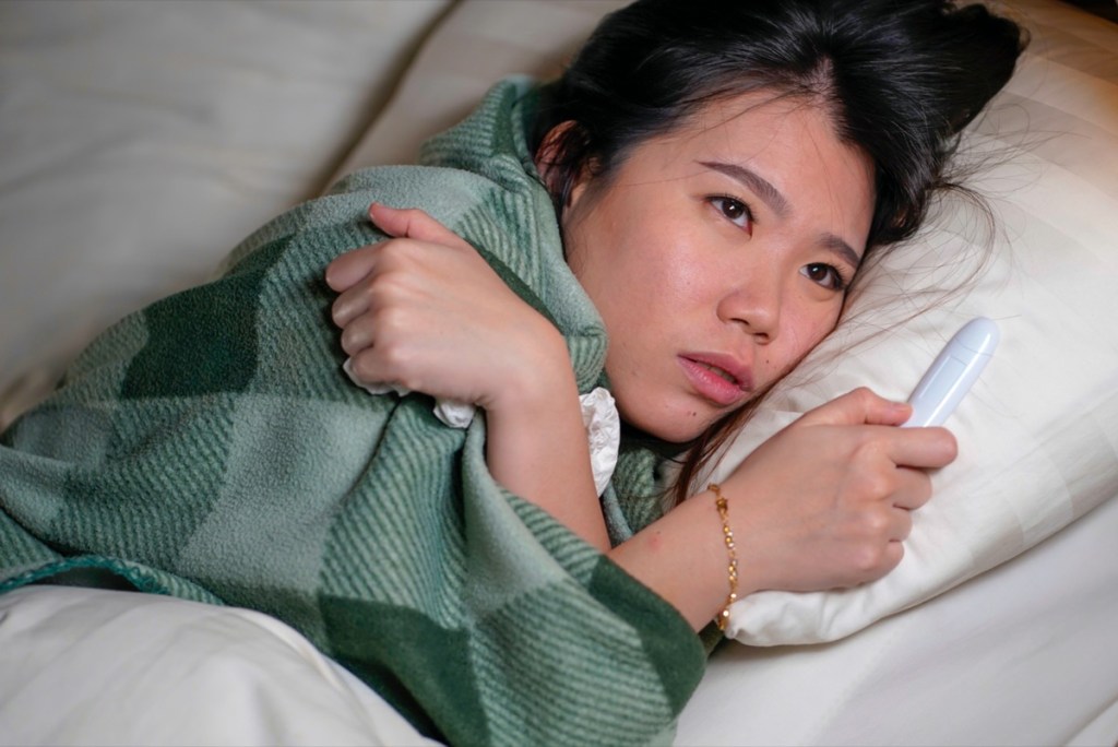 woman-sick-tires-fatigued-bed-sleep