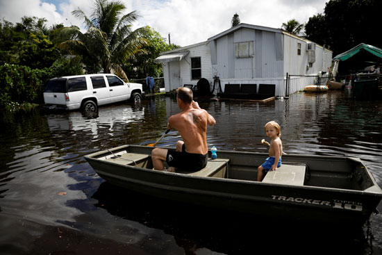أشخاص يجدفون بقارب دواسة في مياه الفيضانات التي سببتها العاصفة إيتا في ديفي (1)