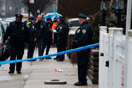 يقف ضباط إنفاذ القانون خارج أحد المنازل في بروكلين بعد ما تنقله وسائل الإعلام المحلية عن إطلاق النار