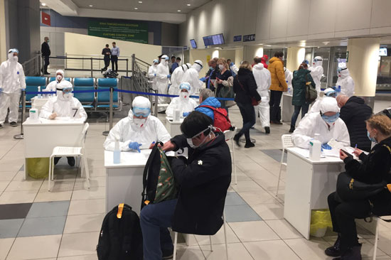 يفحص-المسؤولون-المسافرين-كإجراء-وقائي-ضد-فيروس-كورونا-في-مطار-دوموديدوفو-بموسكو
