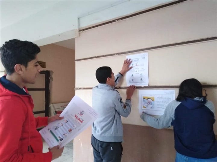 طلاب القاهرة يعلقون ملصقات للتوعية بكورونا (1)