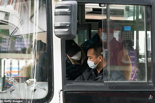 25772366-8094933-Pictured_passengers_and_a_bus_driver_wear_protective_masks_in_Sh-a-15_1583851211673