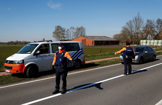 ضباط-شرطة-بلجيكيون-يرتدون-قناعًا-وقائيًا-على-الحدود-البلجيكية-الهولندية-أثناء-الإغلاق-الذى-فرضته-الحكومة-البلجيكية--(1)