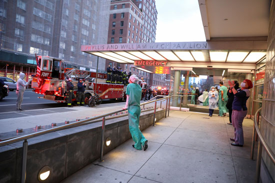 أمريكيون يشاركون رجال الإطفاء فى توجيه التحية للطواقم الطبية بنيويورك