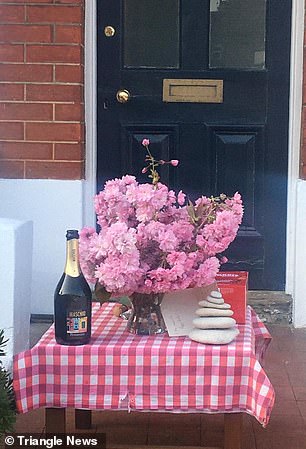 27212608-8220627-A_vase_with_blossom_and_a_bottle_of_fizz_were_left_on_the_doorst-a-8_1586940924325