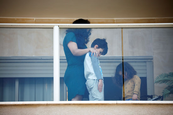 أم وأبنائها يشاركون فى تكريم ضحايا الهولوكوست من شرفة منزلها