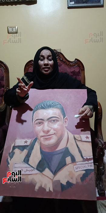 أم الشهيد خالد مغربي دبابة مع صورة للشهيد (3)