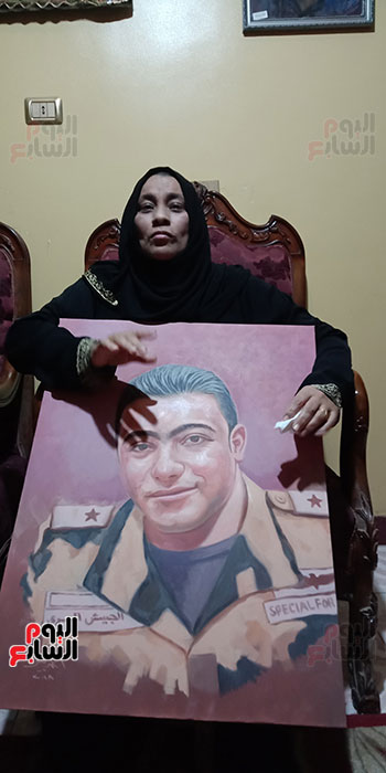 أم الشهيد خالد مغربي دبابة مع صورة للشهيد (5)