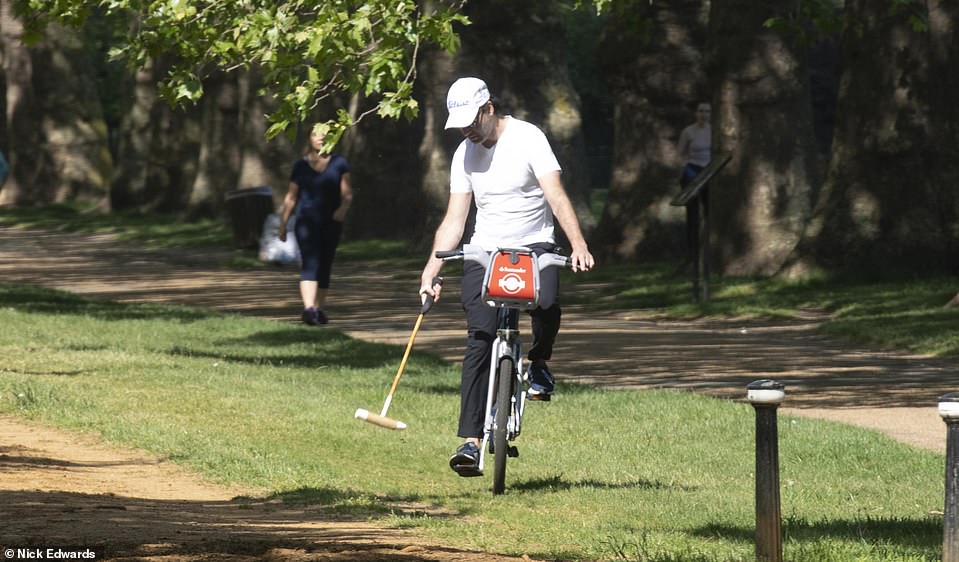 28193402-8304549-A_man_tries_bike_polo_in_Hyde_Park_The_hot_weather_comes_as_the_-a-63_1589106030323