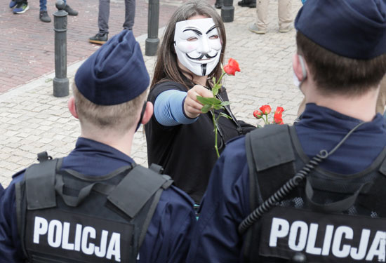 متظاهر يقدم وردا للشرطة فى بولندا
