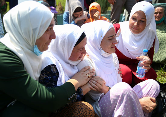 نساء بوسنيات مسلمات يبكين بالقرب من التوابيت في بوتوكاري