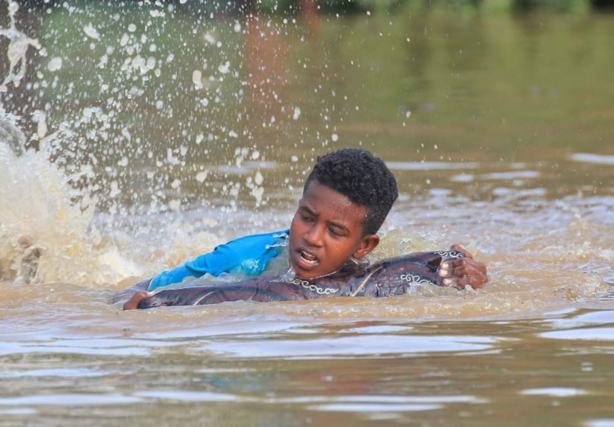 طفل يسبح في مياه الفيضانات