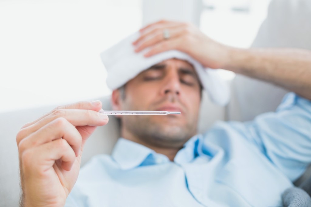 male-sick-ill-home-coach-cold-flu-fever-thermometer-temperature