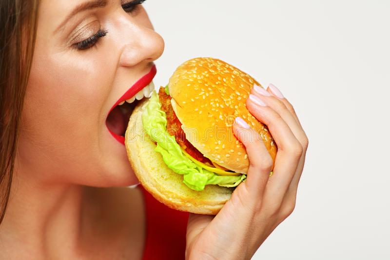 woman-eating-burger-isolated-portrait-white-back-116162191
