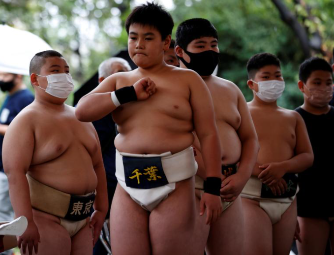 يقف مصارع السومو في المدرسة الابتدائية Kyuta Kumagai بجانب مصارعين آخرين