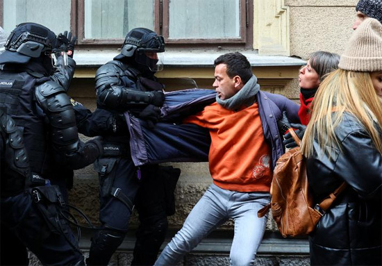 متظاهر يشتبك مع ضباط الشرطة خلال احتجاج على قيود فيروس كورونا بسلوفينيا
