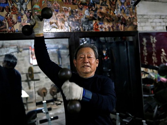 رجل ستيني يتدرب في صالة اللألعاب الرياضية