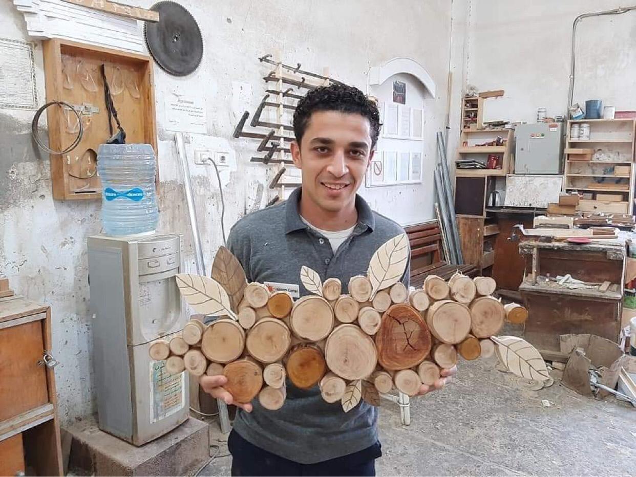 حسام يبدع فى عمل المجسمات الخشبية