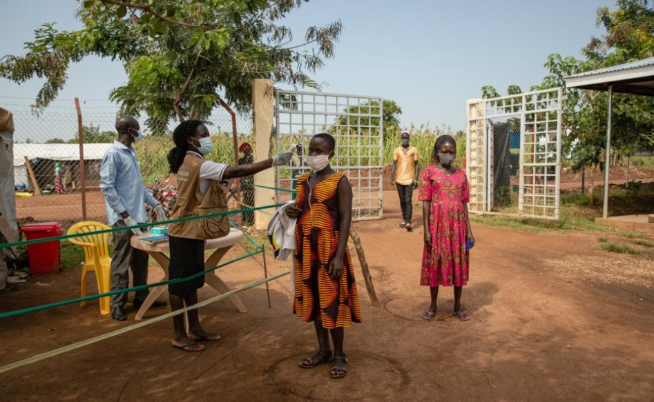 لاجئة من جنوب السودان يتم فحص درجة حرارتها قبل دخول مركز صحي في مخيم بيديبيدي للاجئين في أوغندا