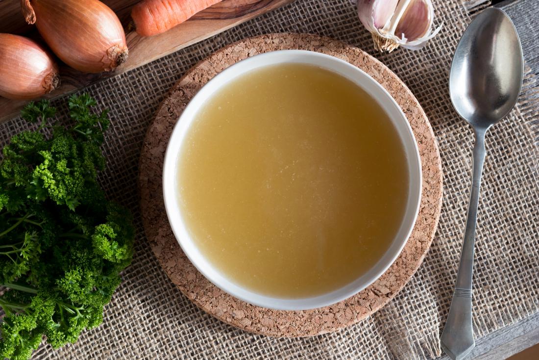 bone-broth-soup-top-down-view-surrounded-by-vegetables