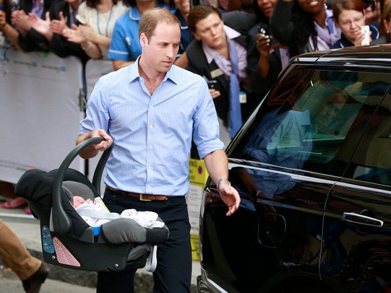 Prince William carrying his child
