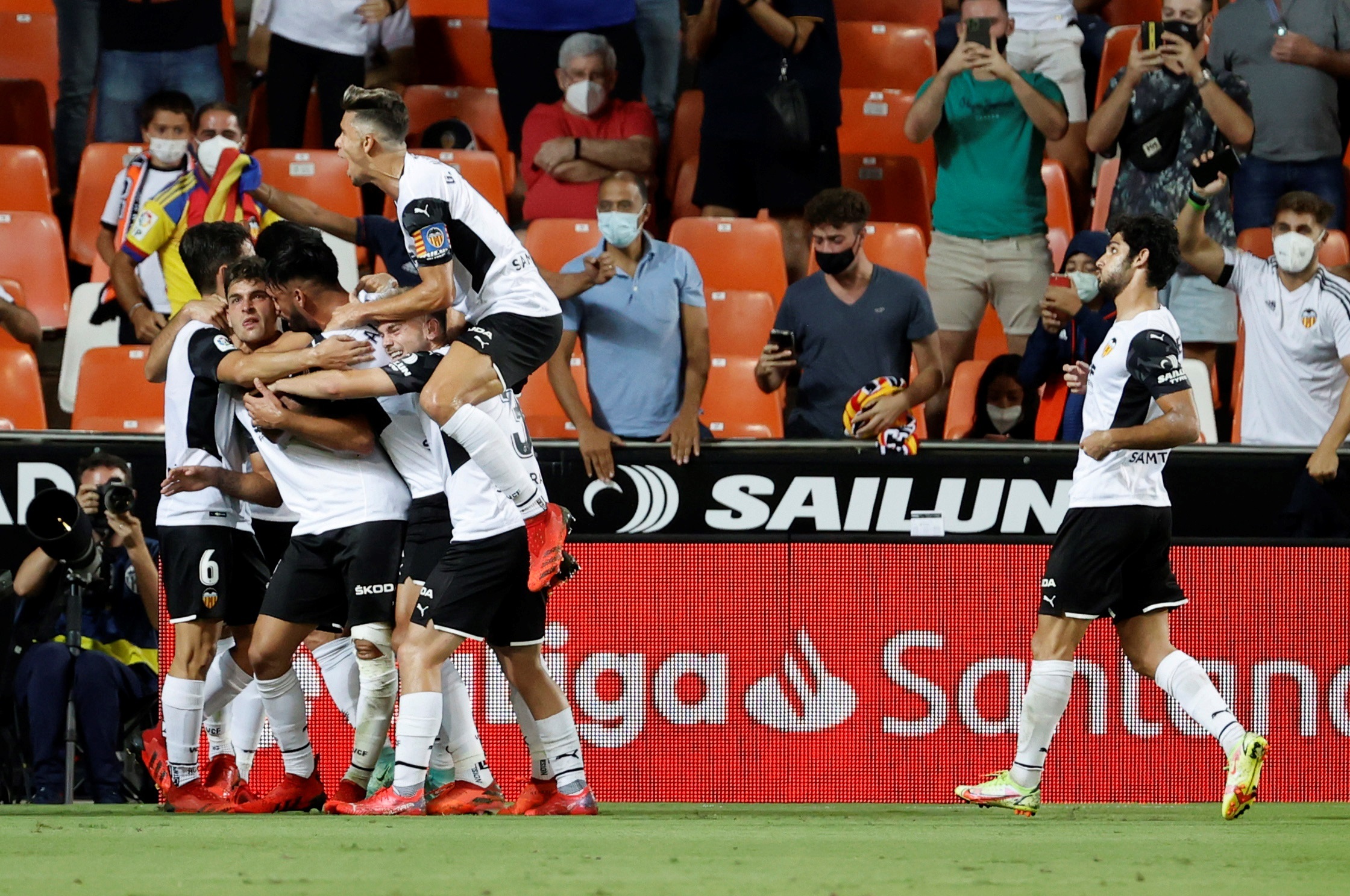 Valencia players celebrate the first goal