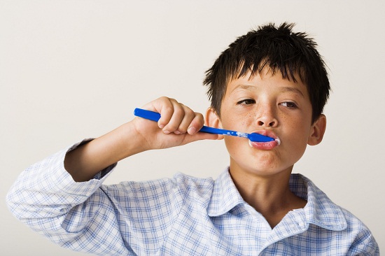 A child brushes his teeth