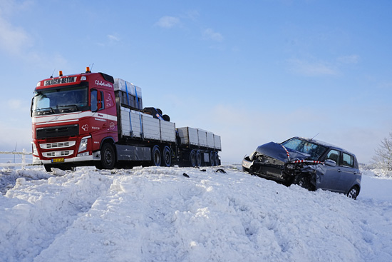 شاحنة تمر بمركبة مغطاة بالثلوج