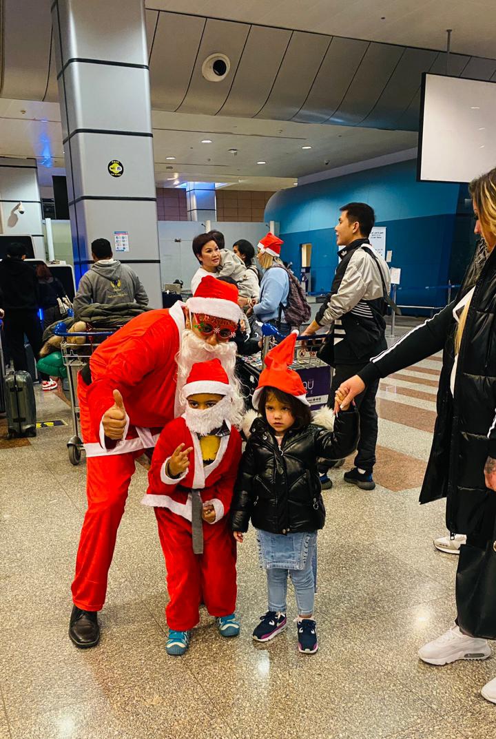 بابا نويل المطار يوزع الهدايا على السياح 