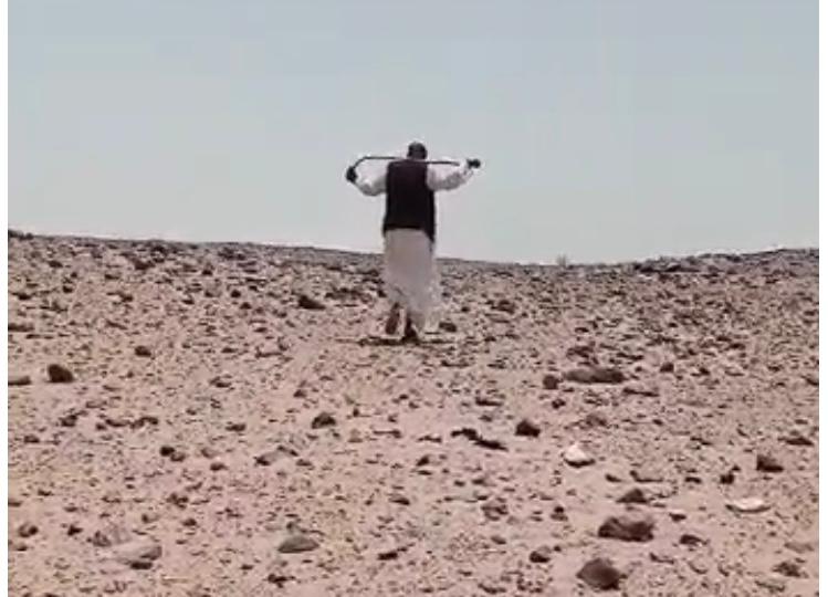 يسير فى الصحراء للكشف آثار الاقدام 