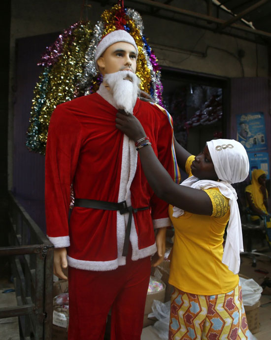امراه تعرض ملابس سانتا كلوز داخل اسواق عيد الميلاد فى ابيدجان