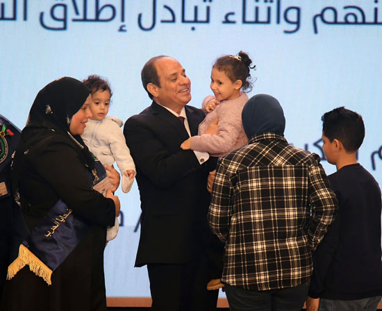 الرئيس السيسي يحمل ابنة الشهيد