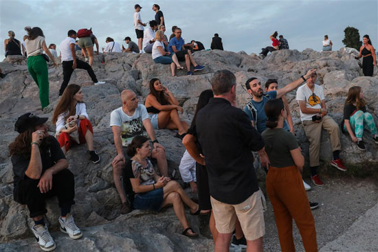 السياح يزورون صخرة أريوباغوس في منطقة الأكروبوليس
