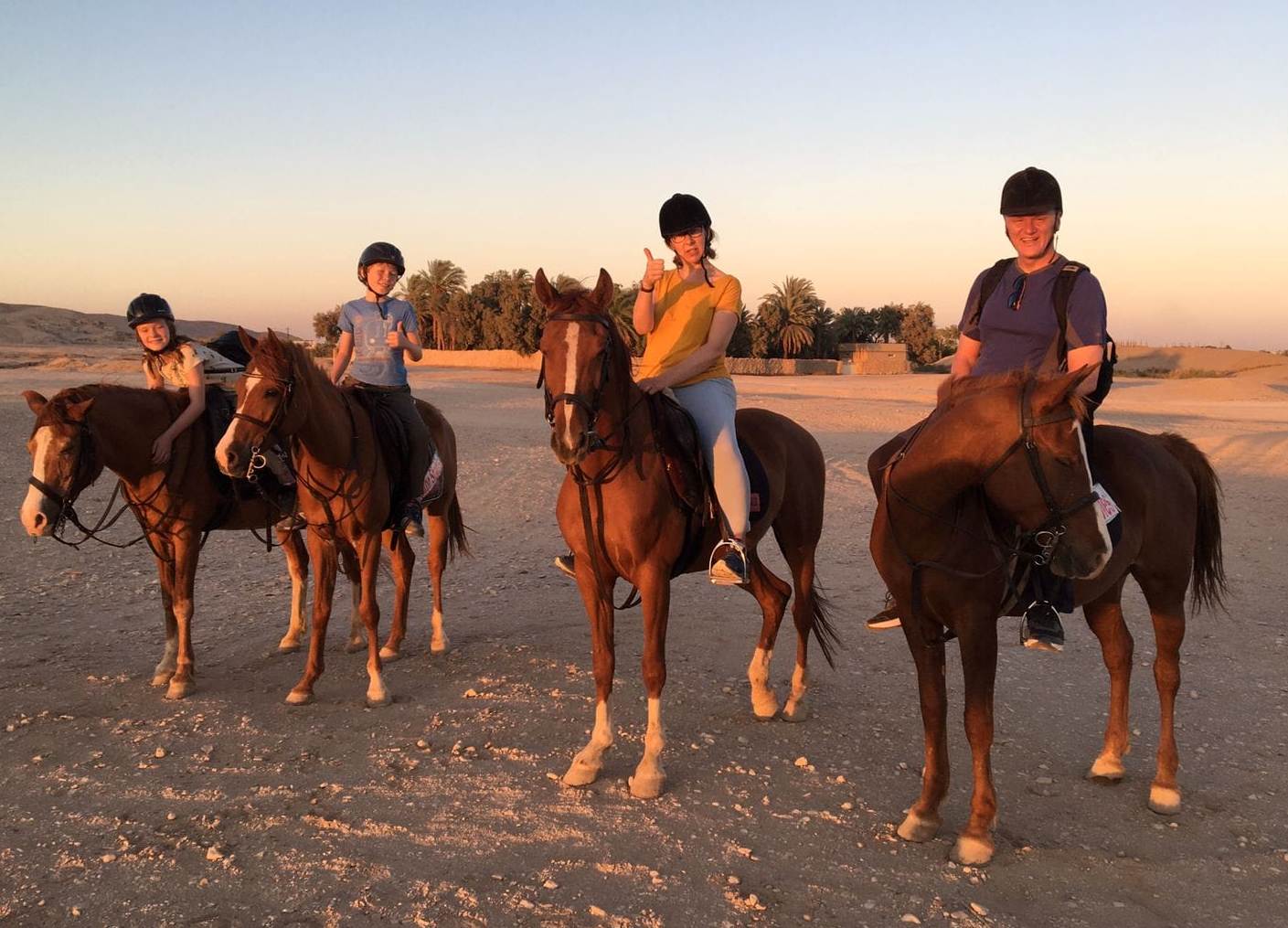 أسرة أجنبية تستمتع علي الخيول في البر الغربي