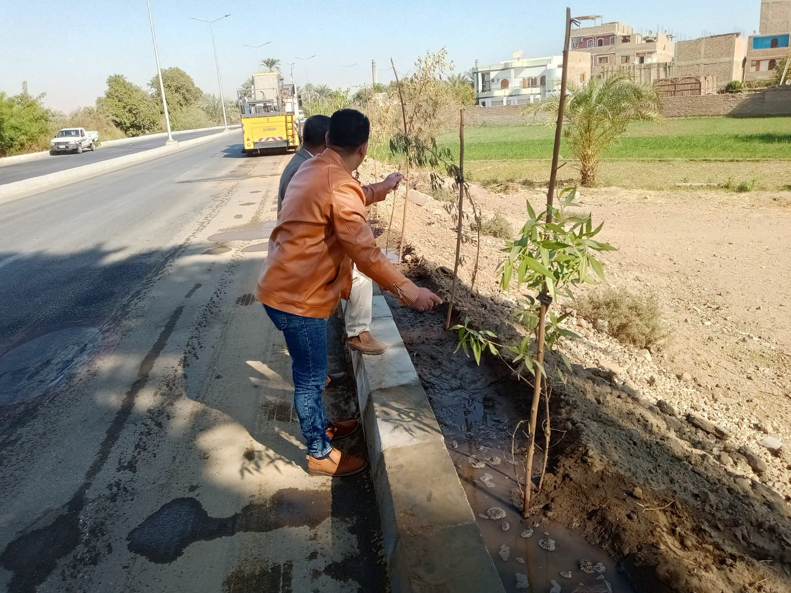 أعمال زيادة المساحات الخضراء بطريق المسار السياحي